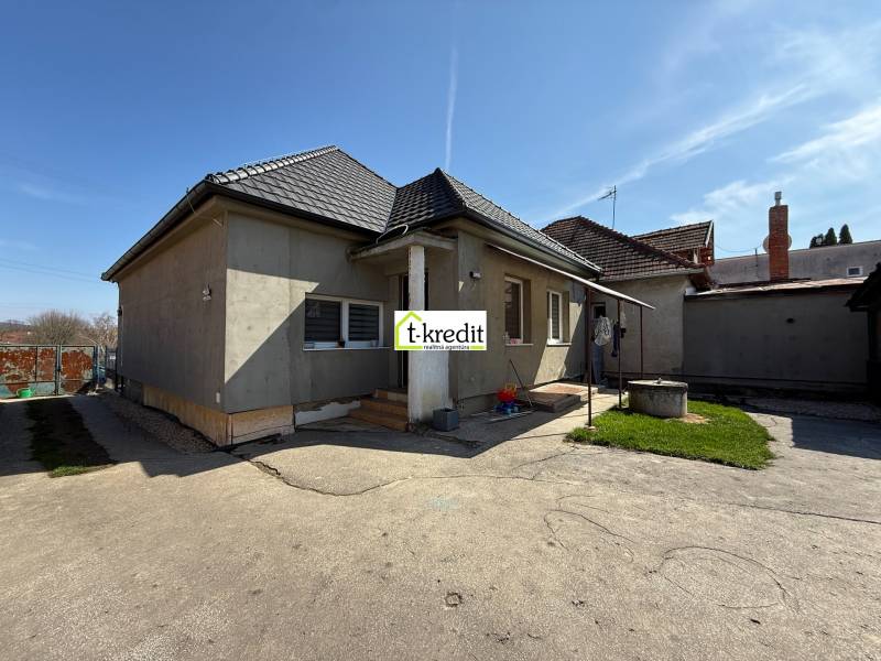 Family house in Zlaté Moravce with an unfinished facade, entrance area, yard with green lawn.