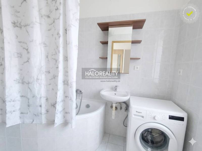 A hallway in a 3-room apartment with a wood-patterned floor and furniture.