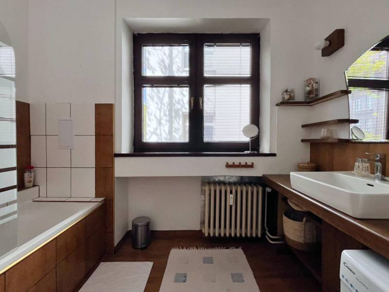 Bathroom with a shower and a sink, wooden decor flooring, 2-room apartment.
