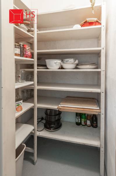Pantry with shelves and kitchenware in a 3-room apartment.