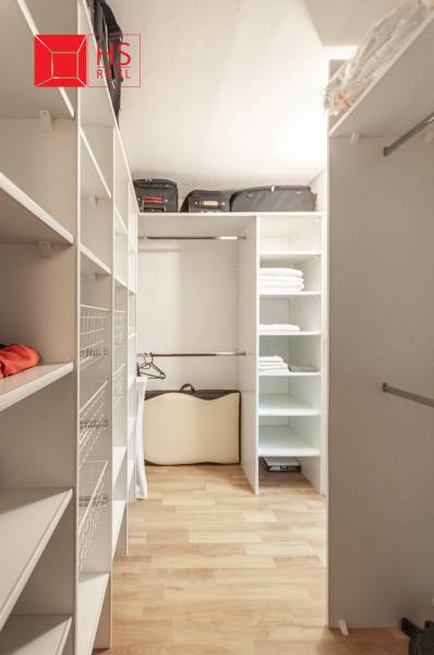 A wardrobe with shelves and a wooden decor floor in a 3-room apartment.