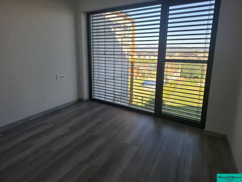 Interior in a family house with large windows and a wooden decor floor.