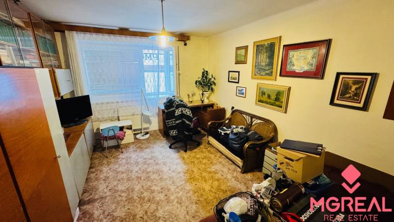 Living room in a 3-room apartment with decorations, furniture, and a wooden decor floor.