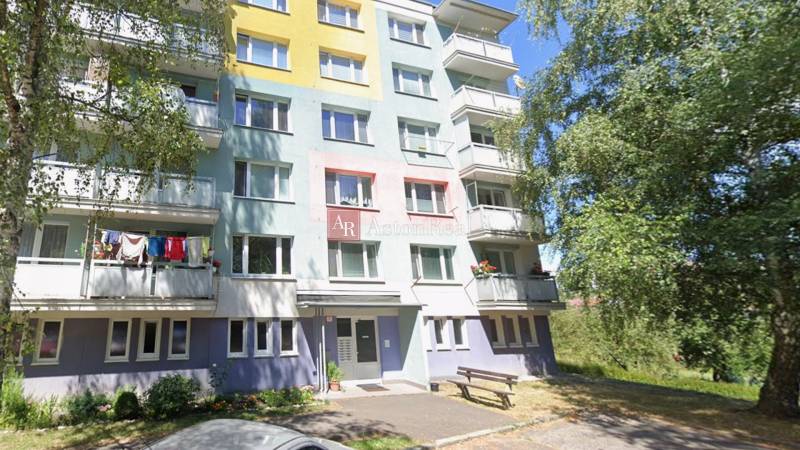 Colorful apartment building on Beskydská 9 in Banská Bystrica, surrounded by greenery.