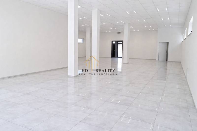 Spacious commercial spaces with white flooring and columns, ideal for business.
