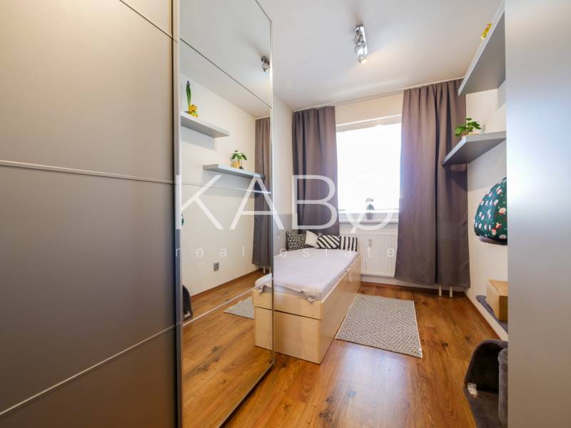 Children's room in a three-room apartment with a wooden decor floor and a built-in wardrobe.
