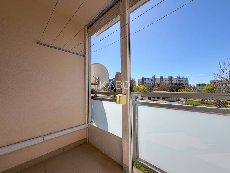 A balcony in a 3-room apartment with a view of greenery and buildings in Nitra on Murániho.
