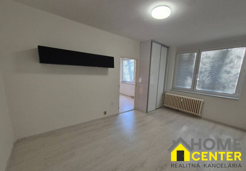 1-bedroom apartment with a built-in wardrobe and flooring with a wood decor, bright interior.