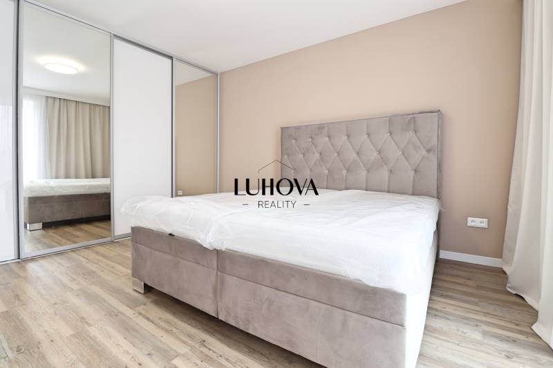 Bedroom in a 3-room apartment with a comfortable bed, built-in wardrobe, and floor with a wooden decor.