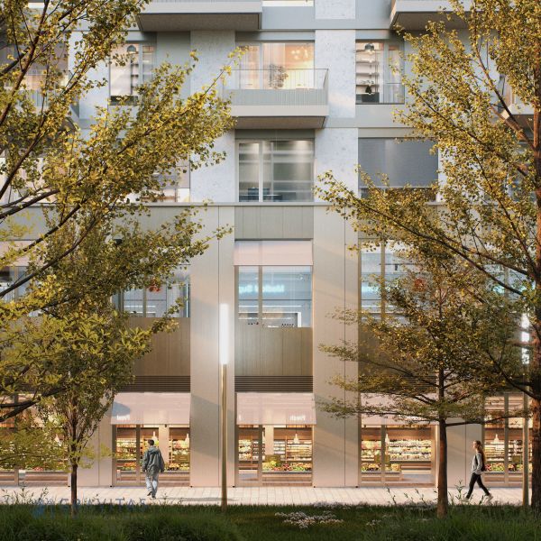 The exterior on Mlynské nivy in Bratislava-Ružinov with shops and trees in front of the building.