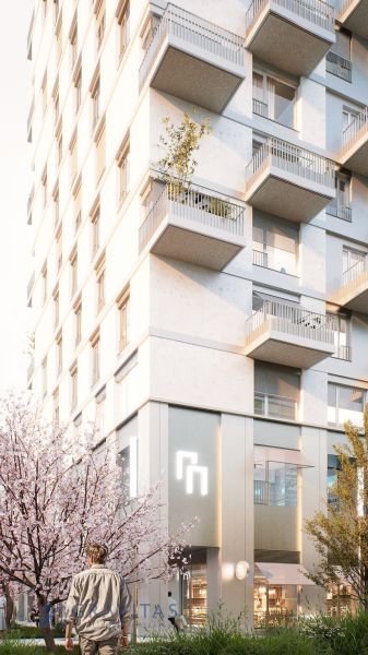 Apartment building on Mlynské Nivy in Bratislava - Ružinov with balconies and blooming trees.
