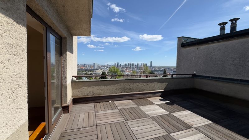 Terrace of a family house in Bratislava - Staré Mesto with a wooden decor floor and a view.