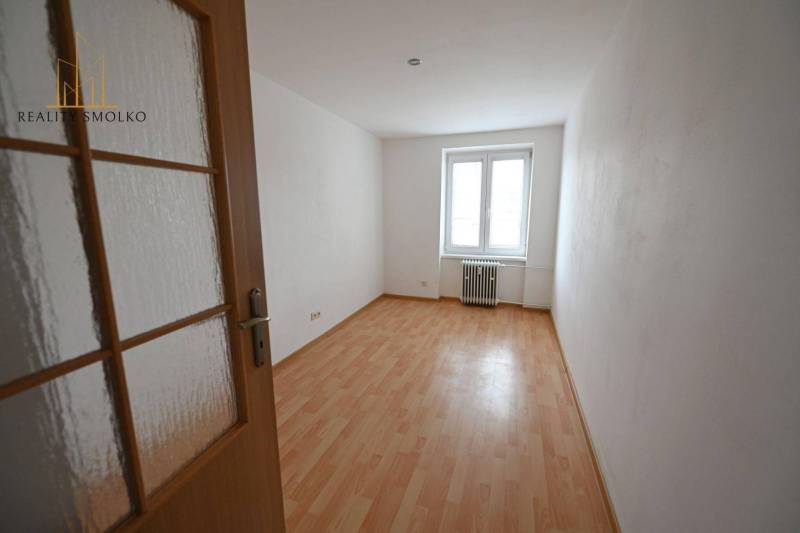 A room with a wooden decor floor in a 2-room apartment, bright room.