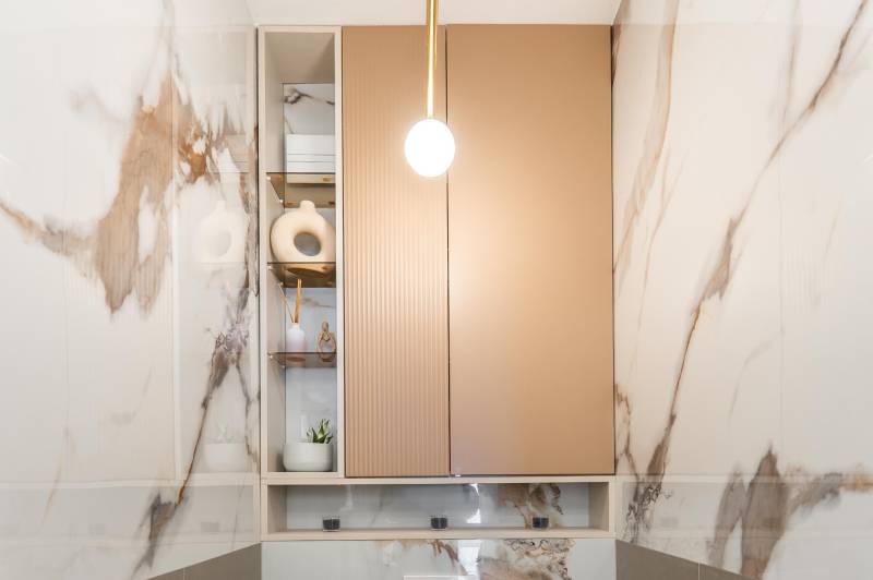 Marble cladding with decorations in the bathroom of a 3-room apartment.