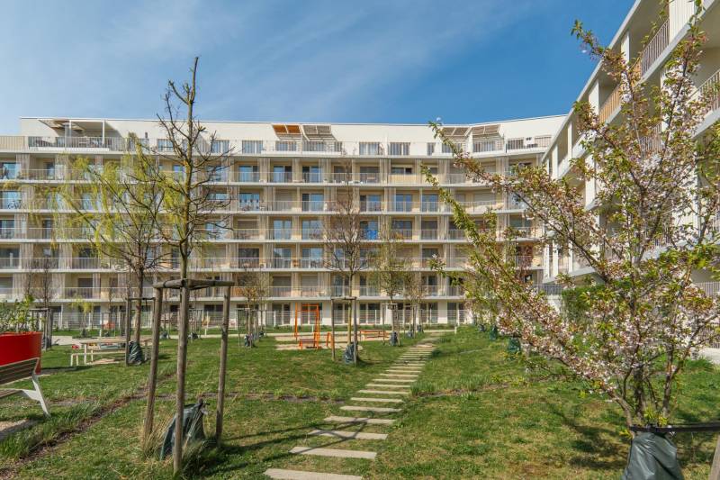 Residential complex in Bratislava - Ružinov with maintained greenery and a children's playground.