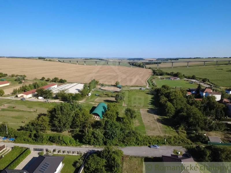 Hosťová offers expansive residential plots surrounded by nature and fields.