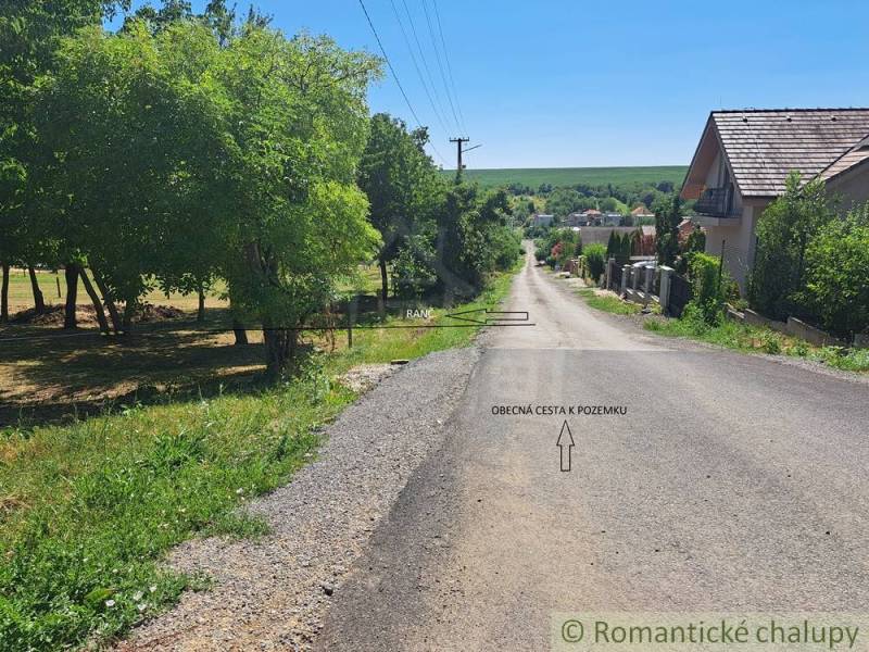 A road in Hosťová surrounded by greenery, suitable for plots - housing.