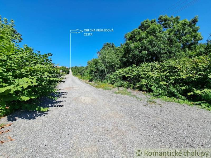 A path surrounded by greenery in Hosťová, suitable for residential plots.