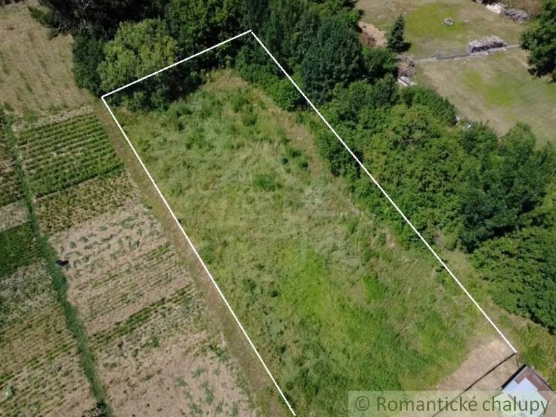 Residential plots in Hosťová, surrounded by nature and trees, ideal for a garden.