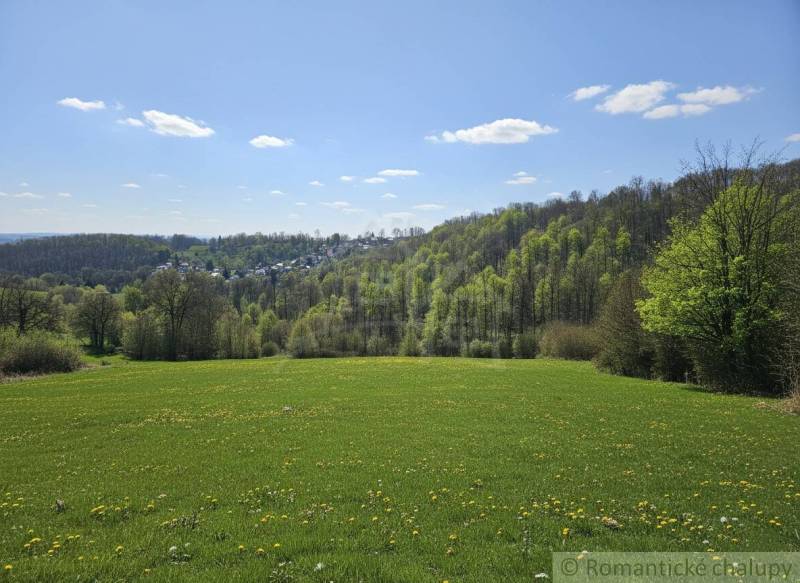 Spring landscape around Krupina, plots - housing, green meadows and forests on the horizon.