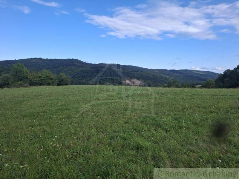 Beautiful green residential plots in Horný Tisovník with a panorama of the forest and blue sky.