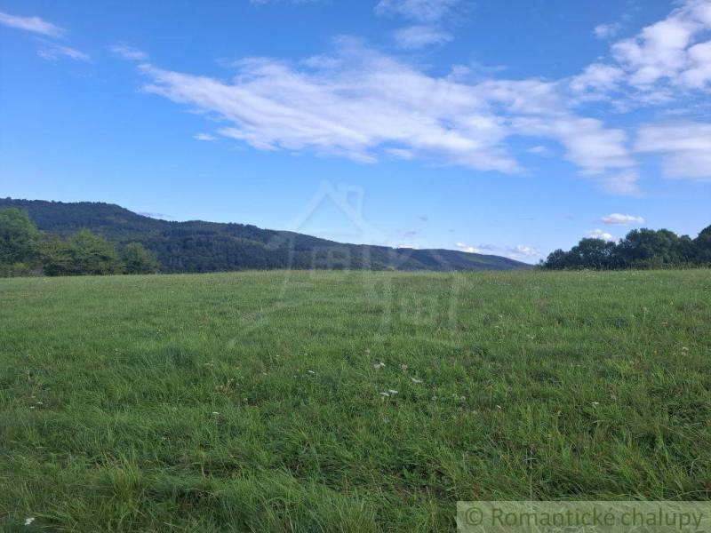 Green meadow with hills and sky in Horný Tisovník, suitable for residential plots.