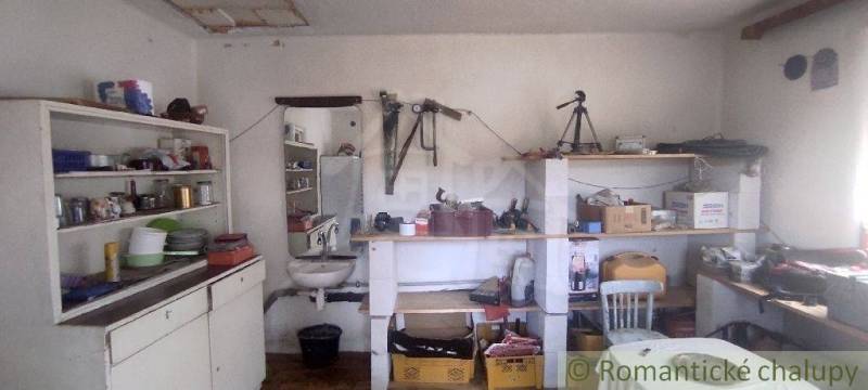 Workshop in a family house with shelves full of tools and accessories.