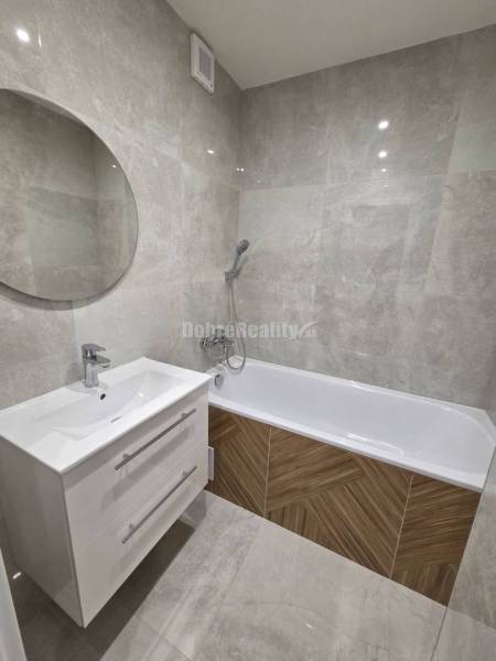 Bathroom with a bathtub and a white cabinet in a 3-room apartment.