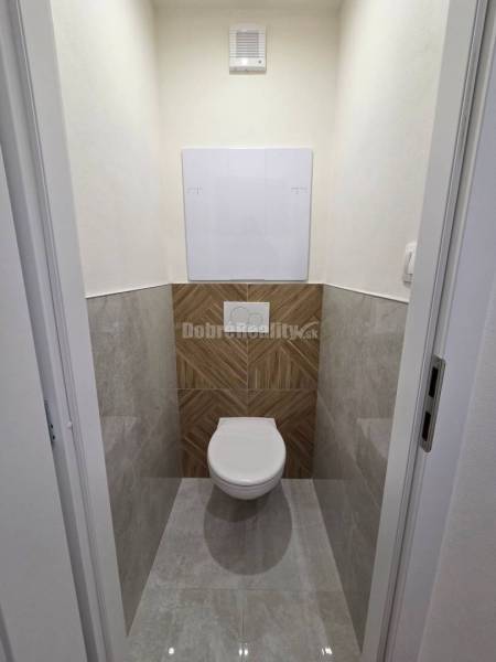 WC with modern tiles and flooring in a 3-room apartment.