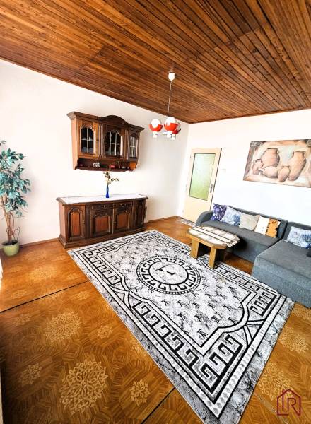 Living room in a family house with a wooden decor floor and a sofa set.