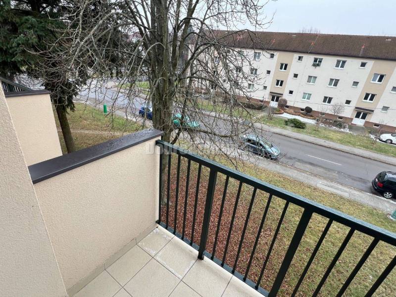The view from the balcony above Svätoplukova Street in Prievidza captures the surroundings of a 2-room apartment.