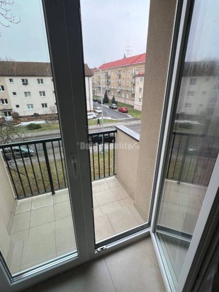 Balcony door in a 2-room apartment with a view of Svätoplukova Street in Prievidza.