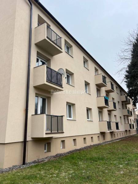 A building with balconies on Svätoplukova Street, Prievidza, offering 2-room apartments.