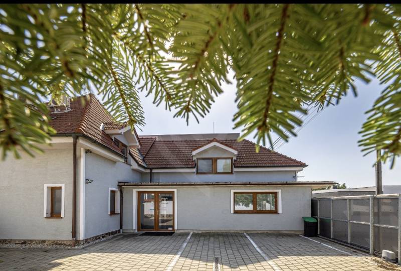 A family house on Podpriehradná Street in Bratislava-Vrakuňa, with a red roof and a spacious yard.