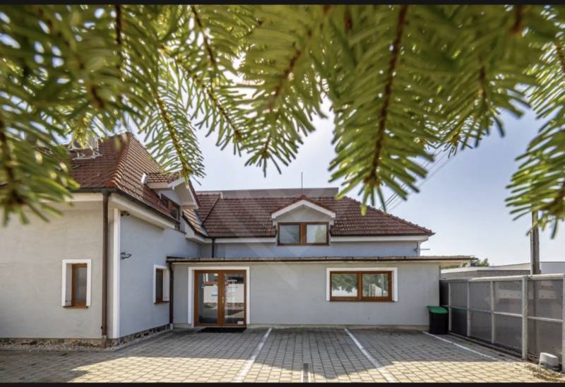 A family house on Podpriehradná Street in Bratislava-Vrakuňa with a red roof and a spacious yard.