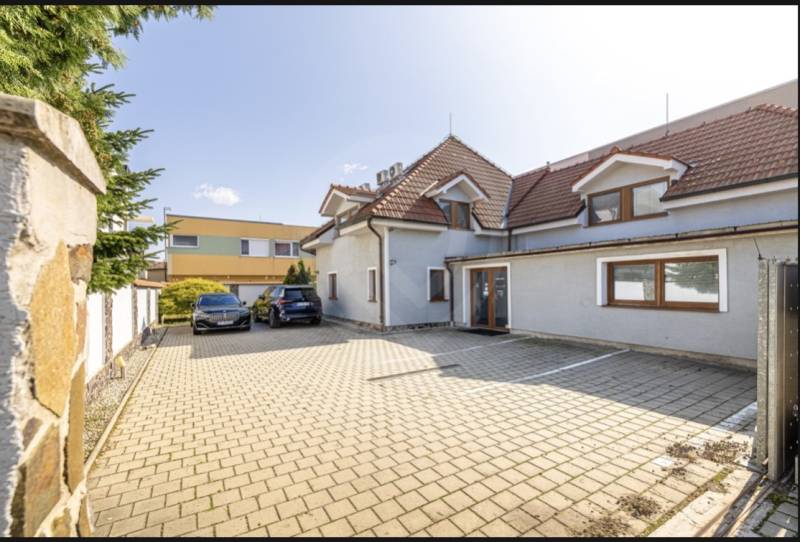 A family house on Podpriehradná Street in Bratislava-Vrakuňa with a spacious paved parking area.