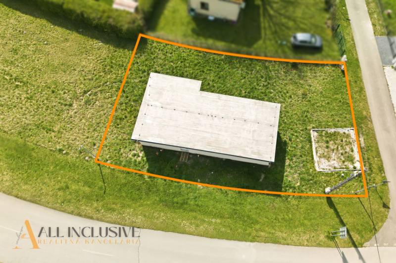 A cottage in Vojka nad Dunajom of rectangular shape, surrounded by a grassy plot.