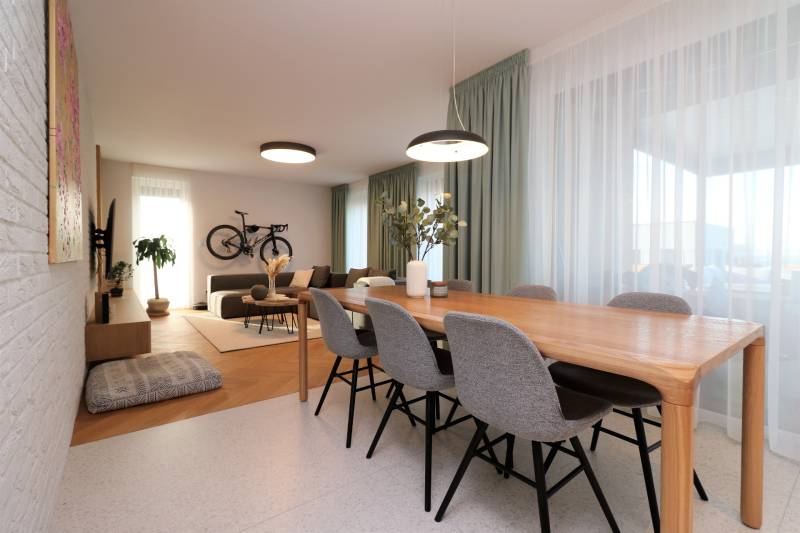 Dining table and living room in a 4-room apartment with a bicycle on the wall.