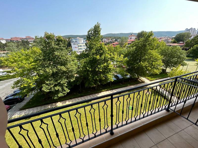 View from the balcony of greenery and parking in Sunny Beach.