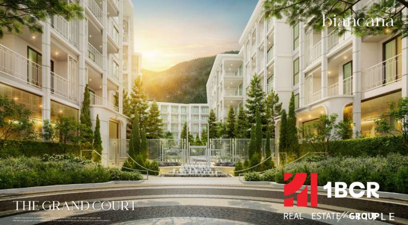 Apartment construction in Phuket with elegant architecture and landscaped greenery in the exterior.