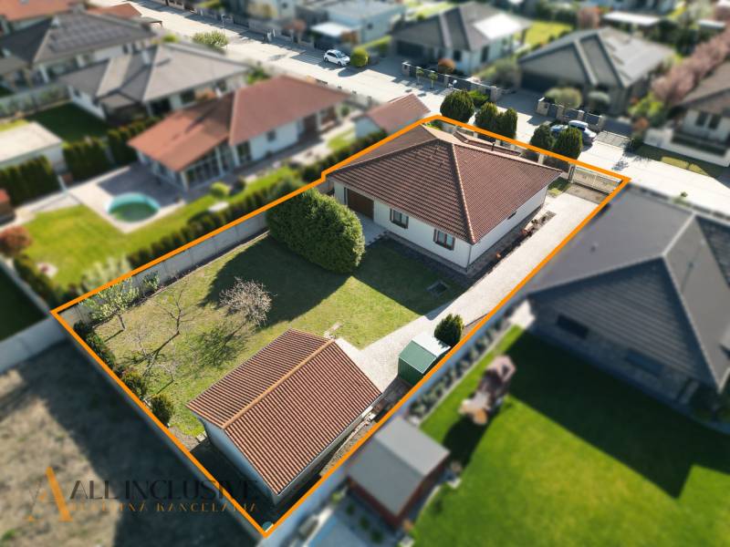 A family house in Kútniky with a garden and parking, enclosed by a fence.