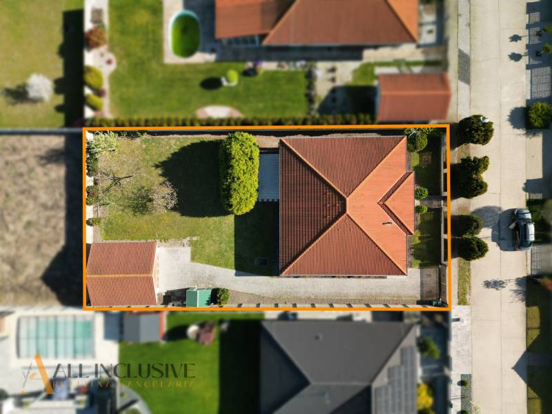 Aerial view of a family house with a red roof in Kútniky.