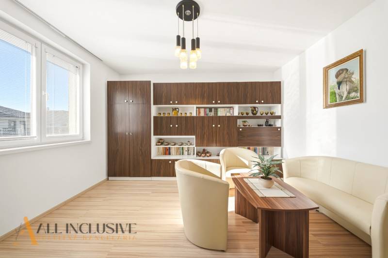 Living room in a family house with a wooden decor floor and comfortable seating.