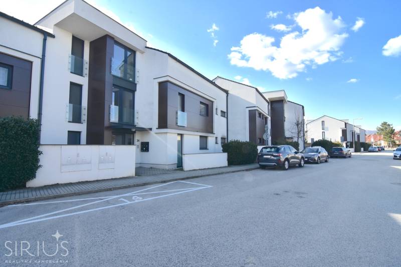 Uhliská Street in Bratislava - Vajnory with row housing and parked cars.