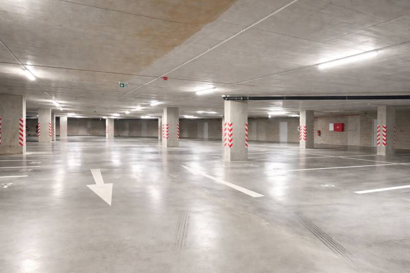 Underground parking with marked spaces and columns in the garage.