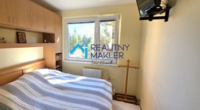 Bedroom with a double bed and built-in wardrobes in a 3-room apartment.