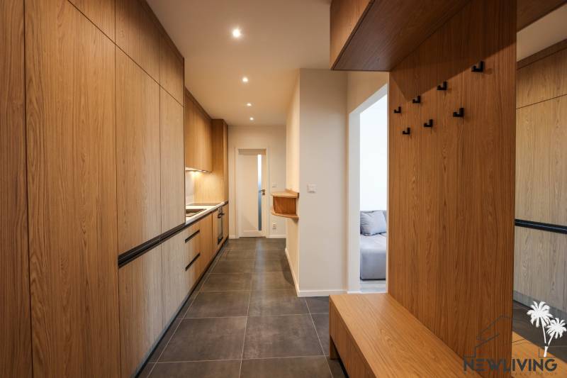 Entrance hall of a 3-room apartment with storage cabinets and hanging hooks.