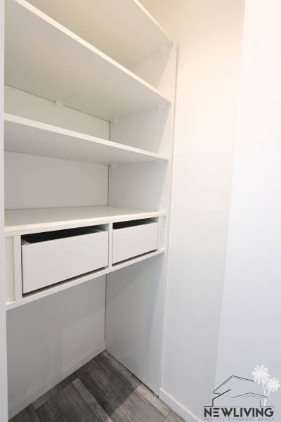 White wardrobe with drawers and shelves in a 3-room apartment.