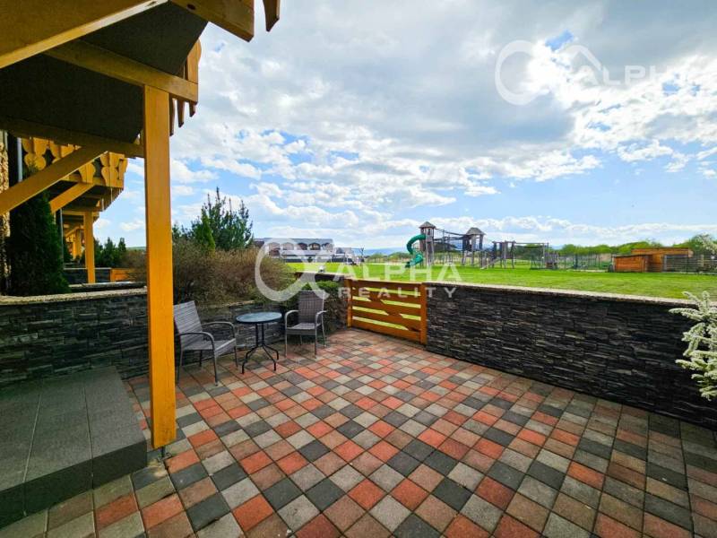 Terrace at a 2-room apartment in Veľká Lomnica with a view of the children's playground and greenery.