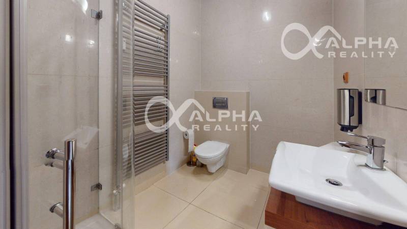 A bathroom in a 2-room apartment with a toilet, shower, and modern sanitary facilities.
